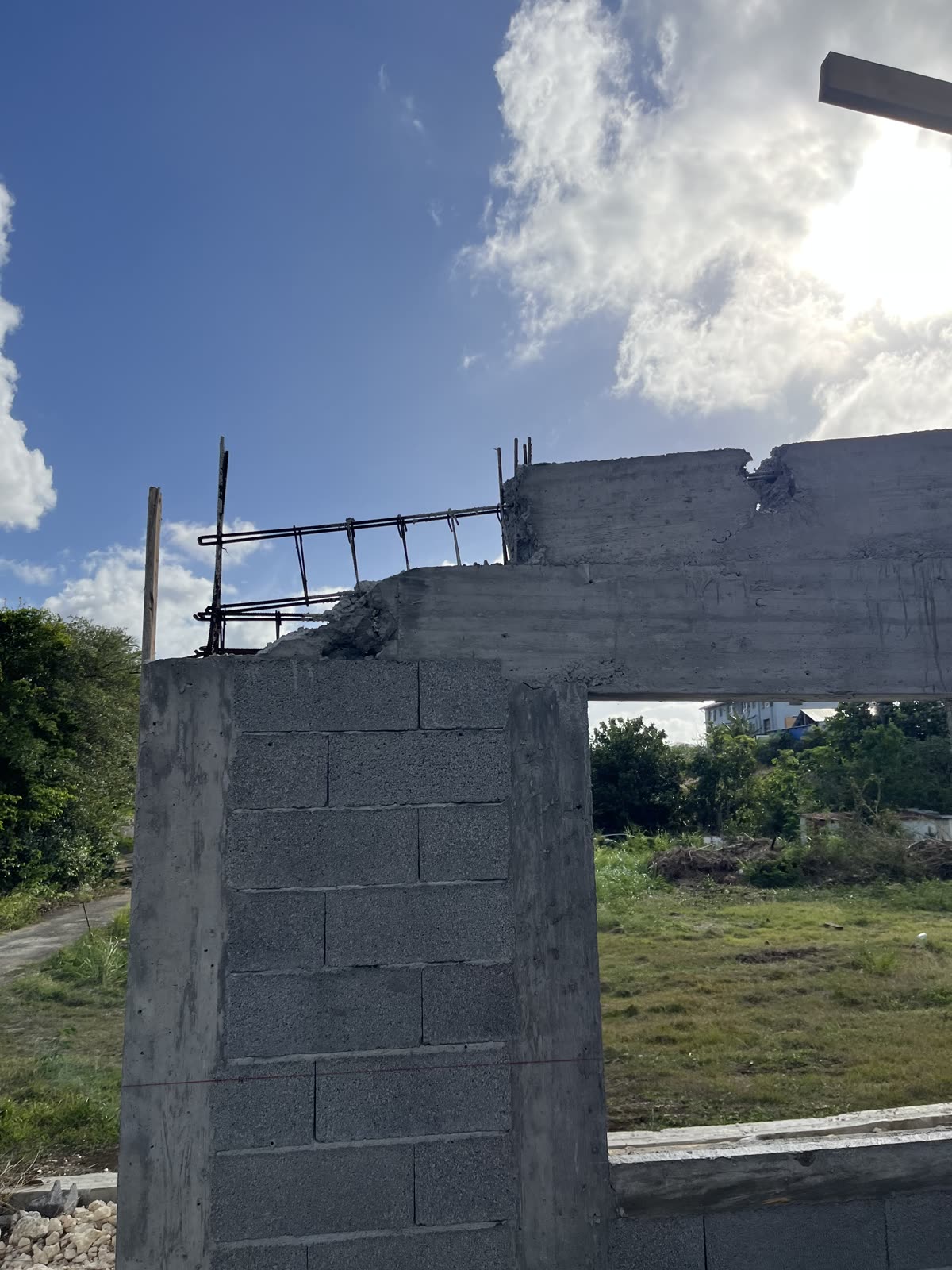 Angle de façade avec armatures en attente et végétation Guadeloupe